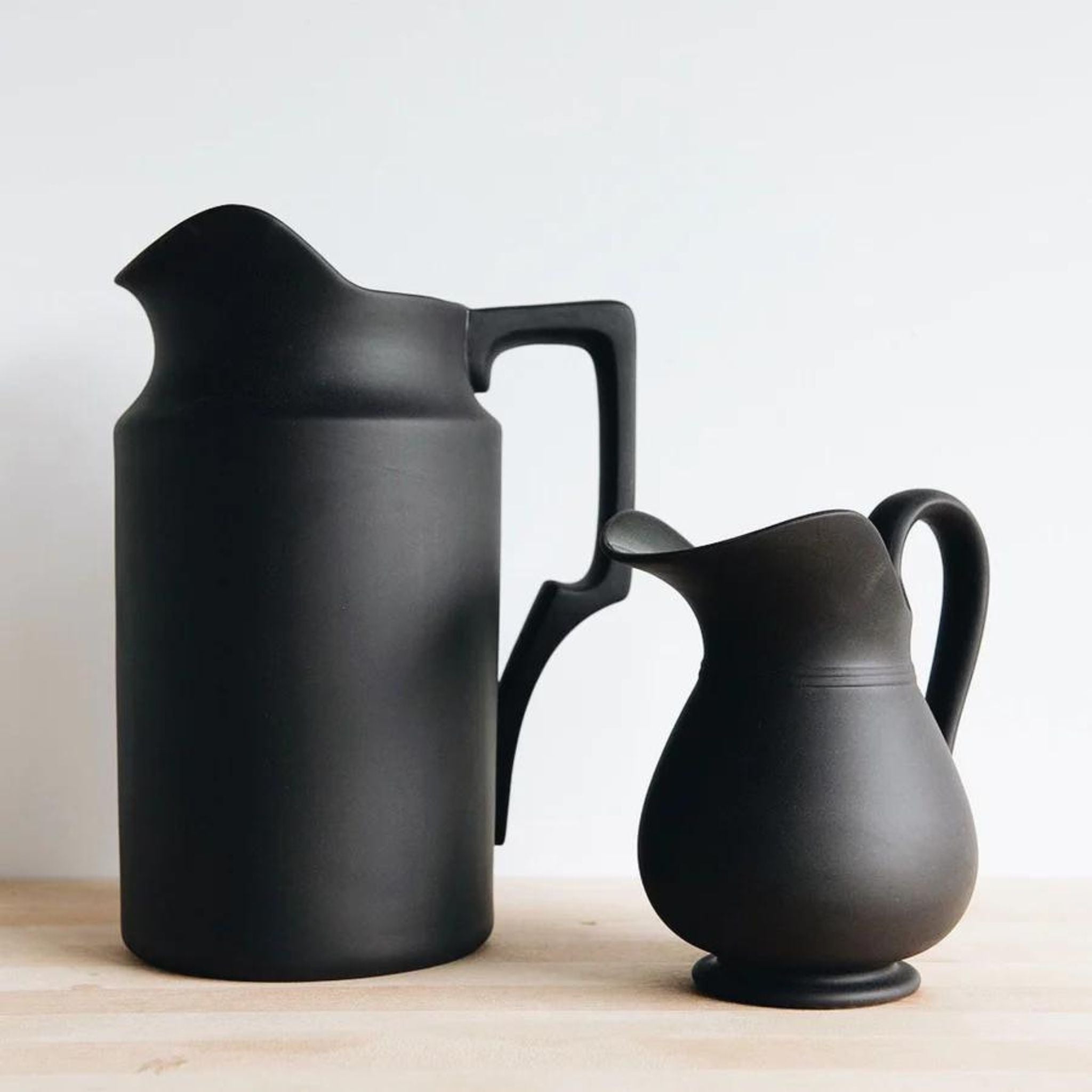 Simply Elevated - Stoneware pitcher meticulously carved by hand and then slip-cast in Sri Lanka. Available in a matte black terracotta with a shiny glazed interior. We love them for serving drinks, holding flowers, or standing proud on the mantel.